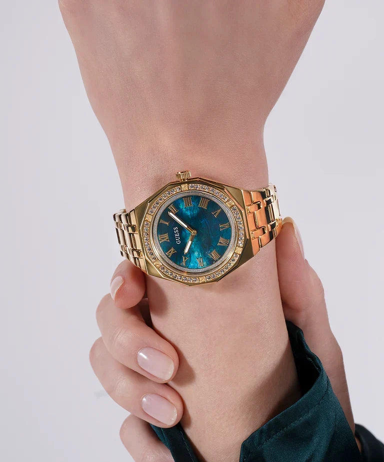 GUESS GW0770L2 gold tone watch worn on wrist showing blue dial and crystal bezel
