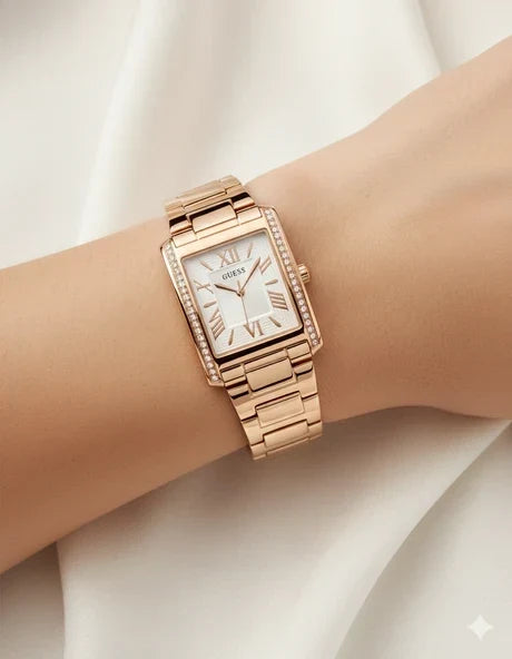 Guess GW0874L3 gold watch on wrist showing rectangular face with Roman numerals and crystal bezel