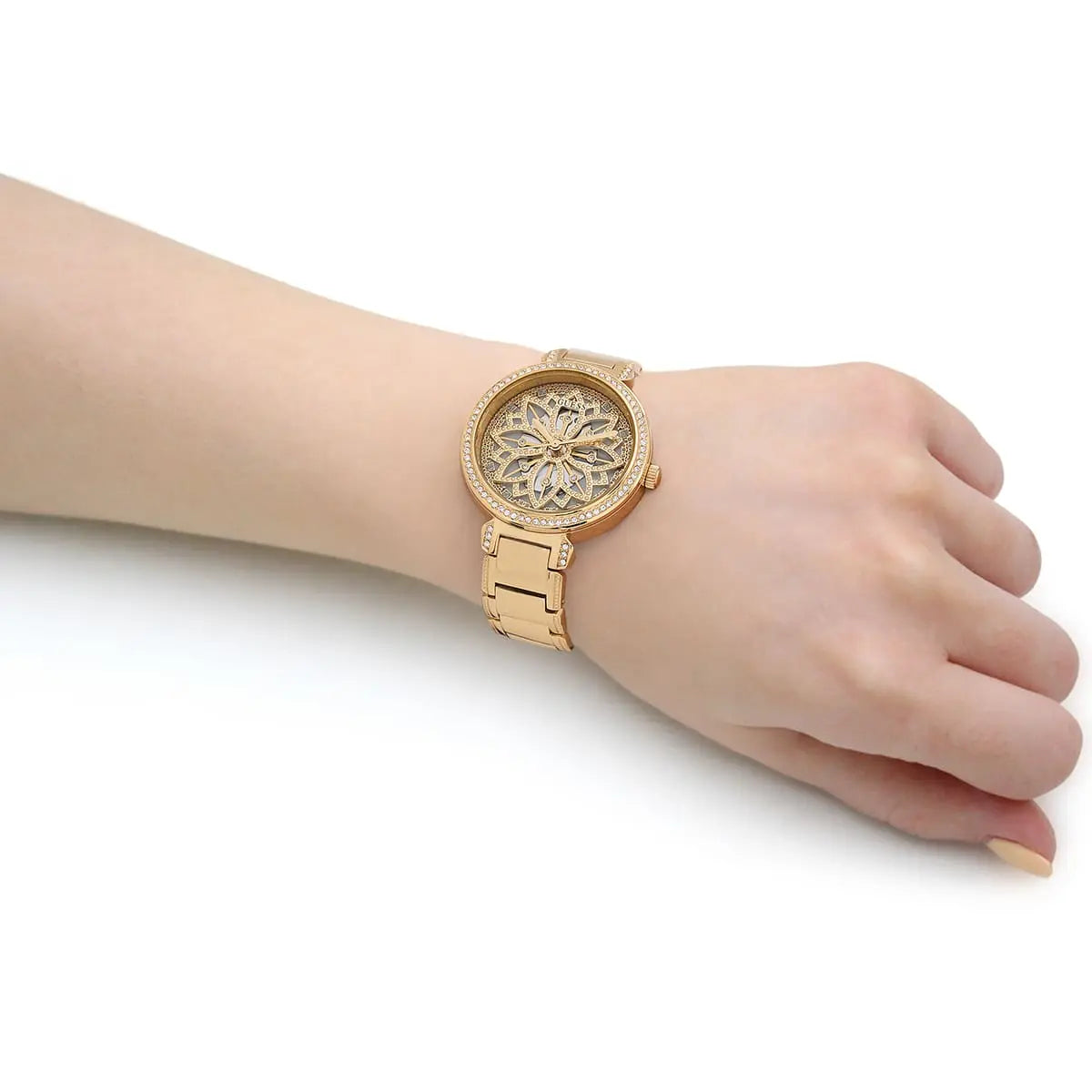 Guess Lily women's watch on wrist showing gold case, crystal dial, and bracelet strap