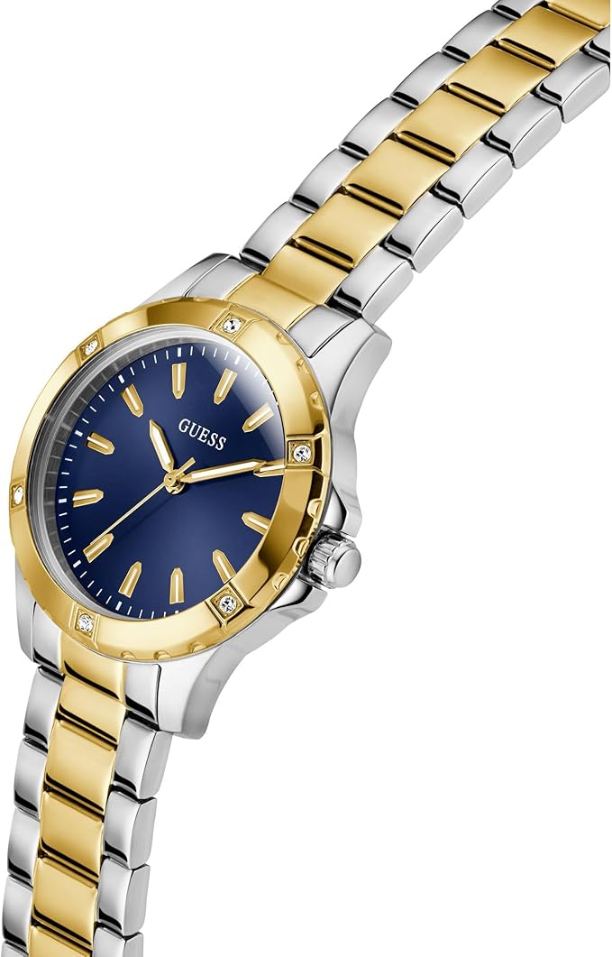 Angled view of Guess Mist watch with blue dial, gold-tone bezel, and two-tone metal bracelet
