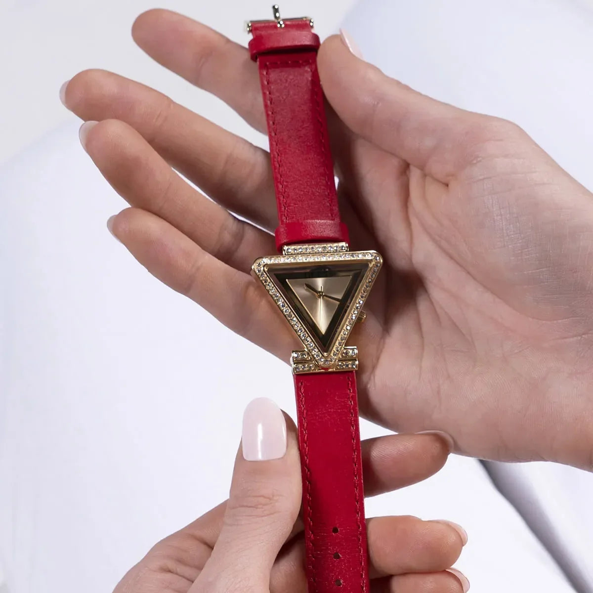 Guess GW0504L2 watch detail view held in hand showing triangle case design