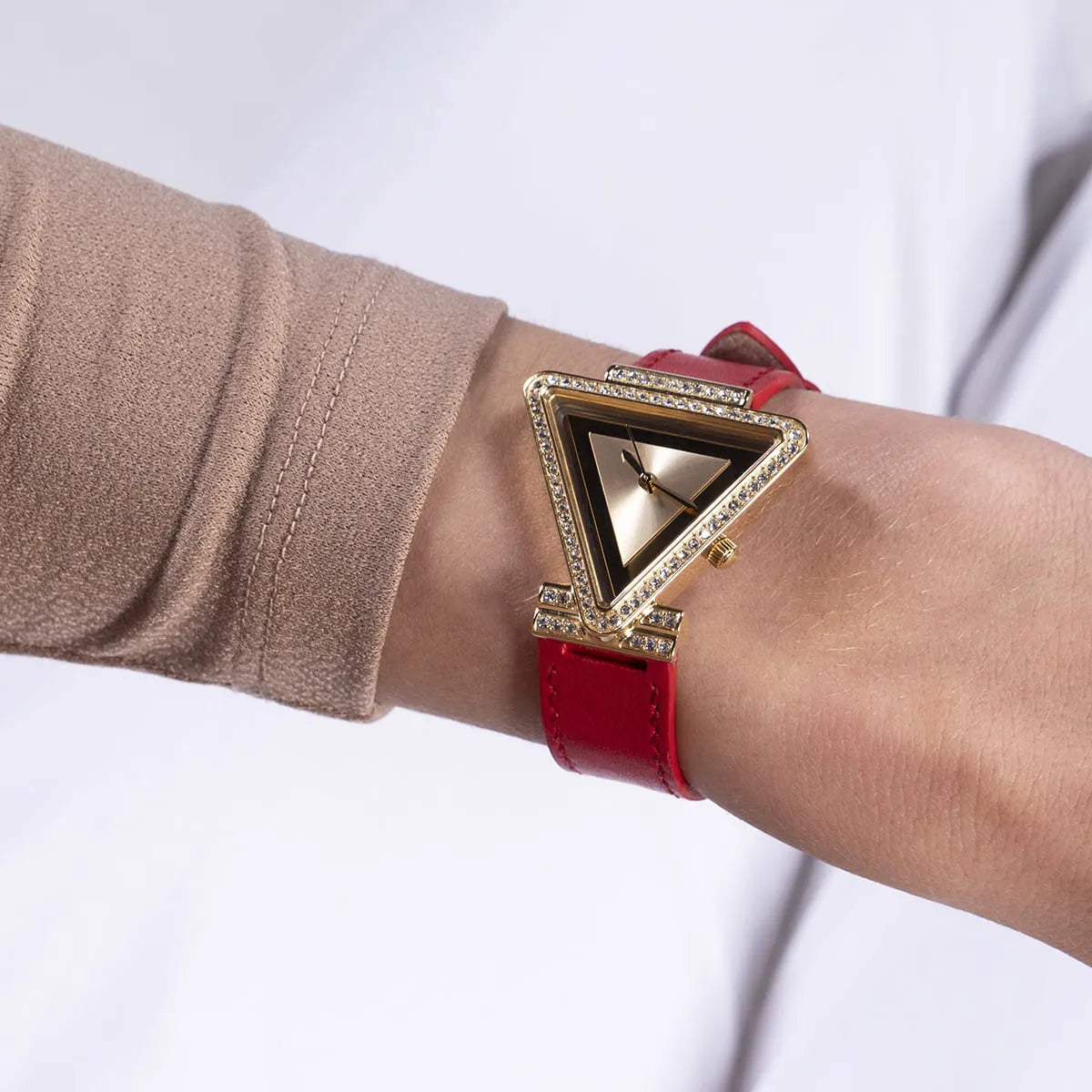 Guess GW0504L2 women's watch worn on wrist with triangle gold dial and red strap