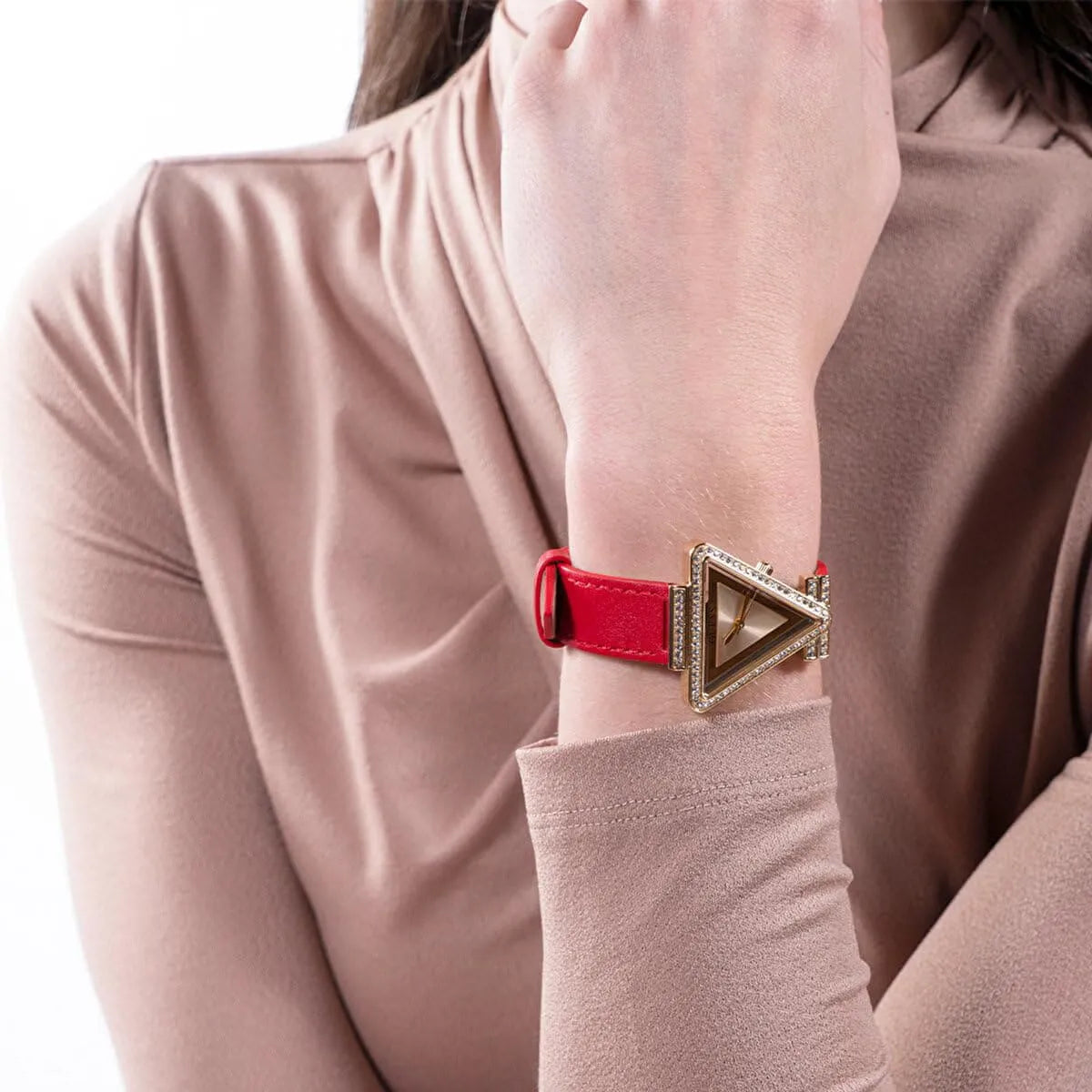 Guess GW0504L2 women's watch on wrist displaying triangle dial and red leather strap