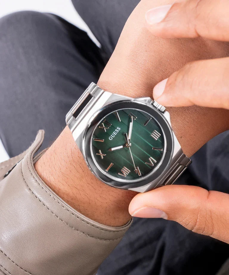 GUESS GW0789G1 watch worn on wrist with green dial and silver stainless steel case